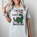 I believe in Santa and Dinosaurs - T-Shirt -  Print is Sublimation, Unisex T-Shirt, Funny Tee,Gift Idea, Womenswear...