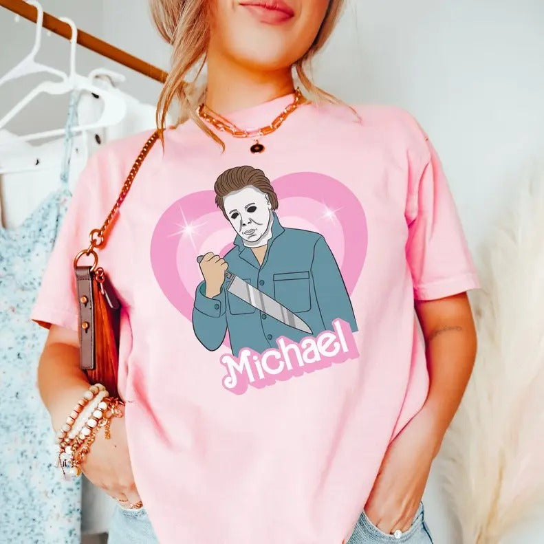 Michael doll tshirt, horror movie doll tshirt, funny Halloween graphic tee, pink spooky shirt, retro aesthetic, scary...