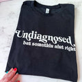 Undiagnosed but something aint right Comfy Colors Long or Short Sleeve Graphic Tee Unisex Screen Printed T-Shirt...