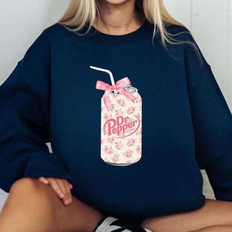 [Up To 5XL] DR. Pepper Sweatshirt, Pink Bow Coquette Dr. Pepper Shirt, Trendy DR Pepper Shirt, Vintage Bow Collage Hoodie...